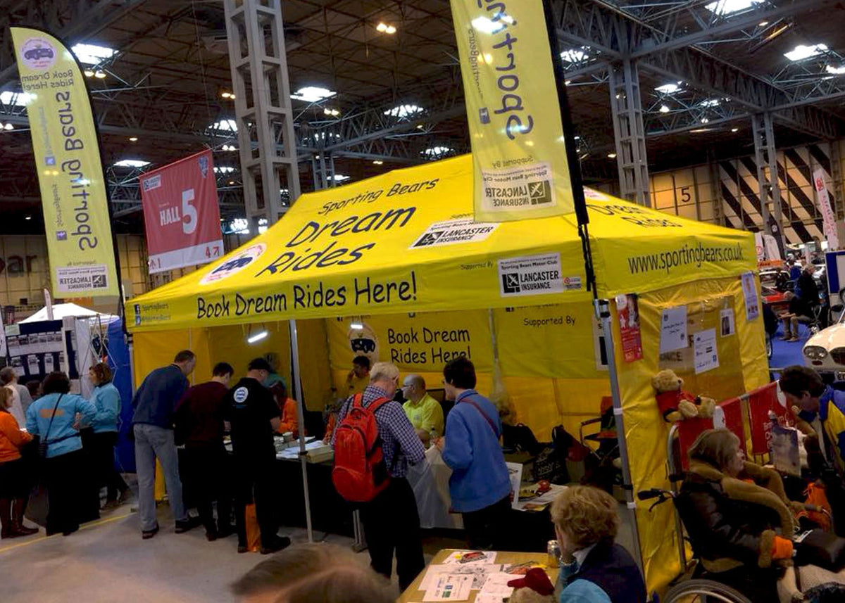 custom printed gazebo with branded flags produced surf & turf instant shelter for a trade show