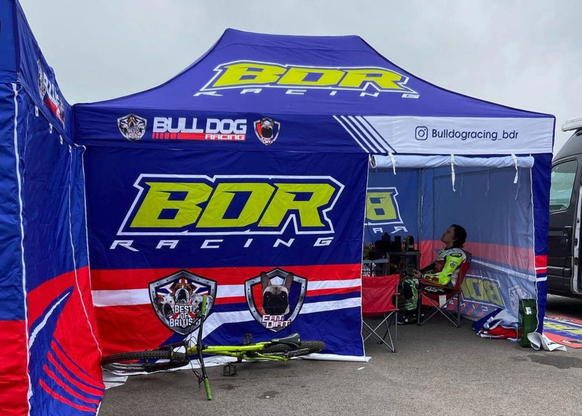 A motorsport teams custom printed gazebo in the race paddock printed by surf & turf instant shelters
