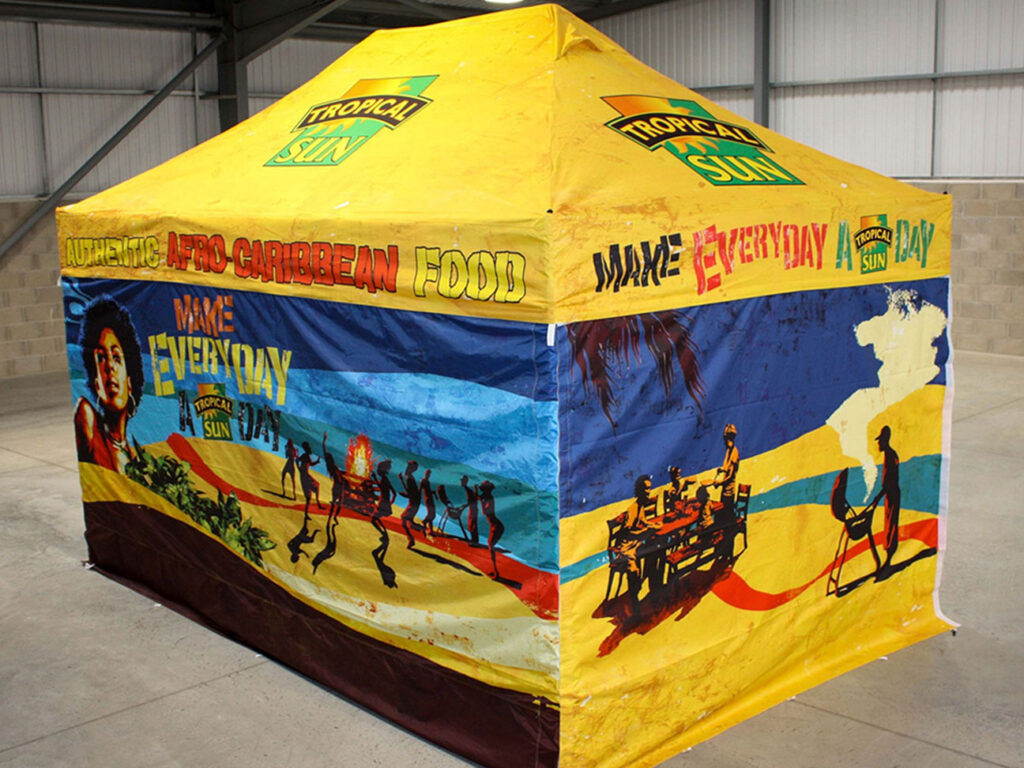 A vibrant custom printed street food gazebo in a warehouse setting.