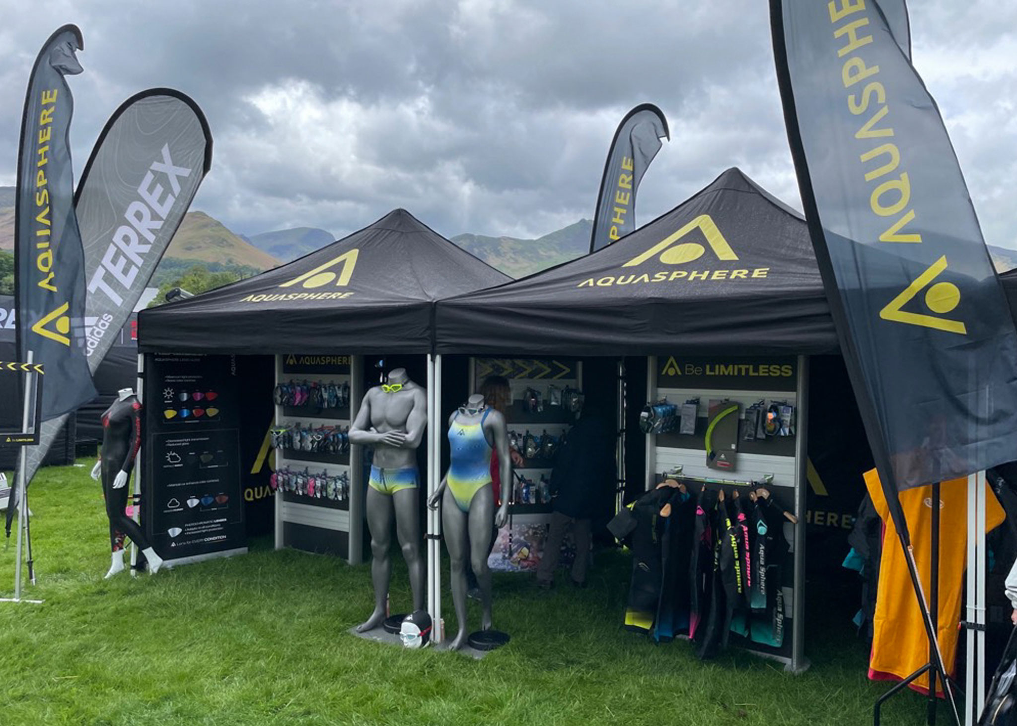 custom branded pop up gazebo stall at a festival selling aqua sphere and adidas terrex