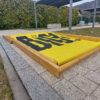 Folded Giant custom deckchair on a paved surface, demonstrating compact storage and easy transport capabilities.